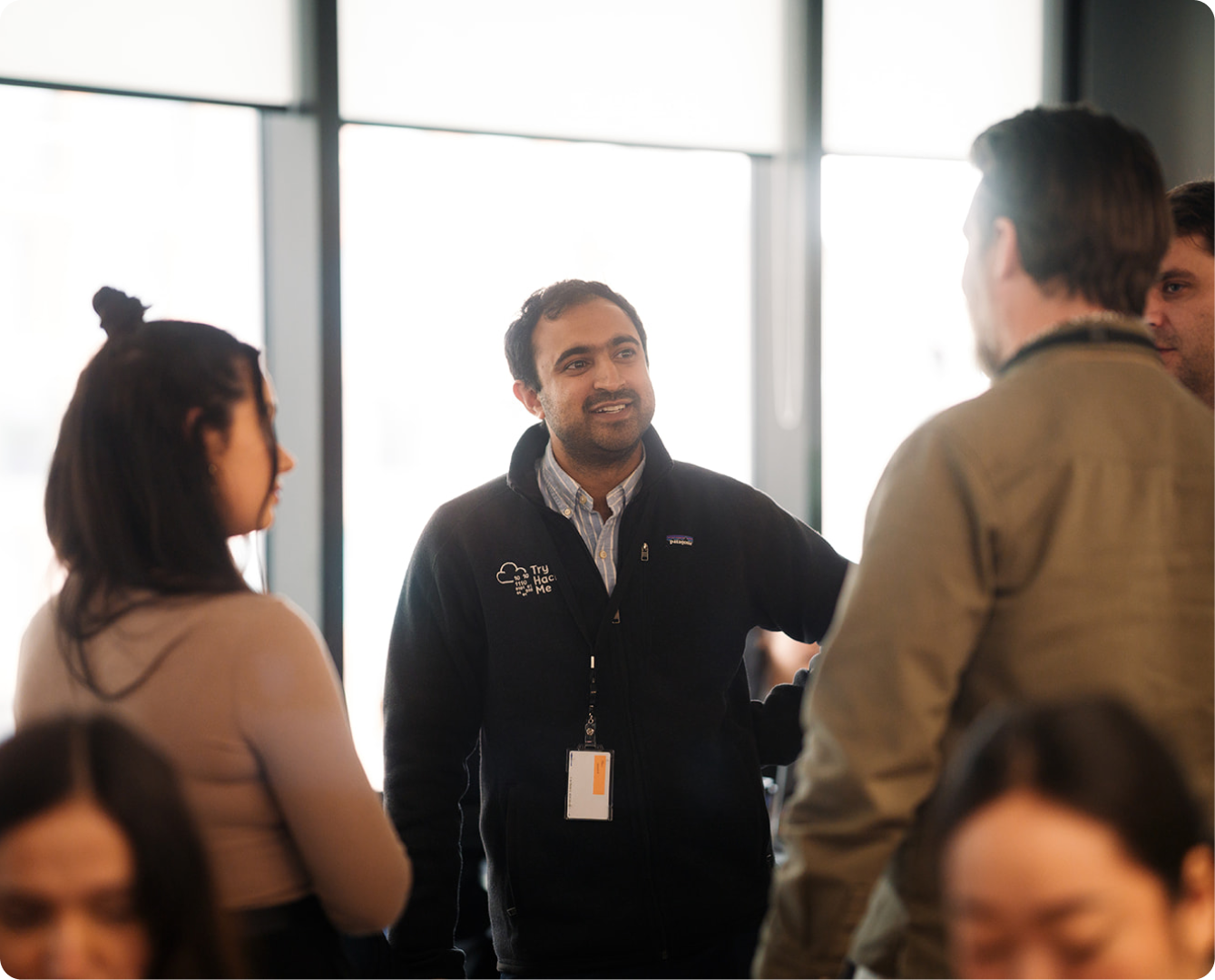TryHackMe team member networking with event attendees.