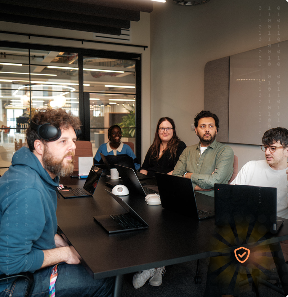 Security team collaborating around a conference table.